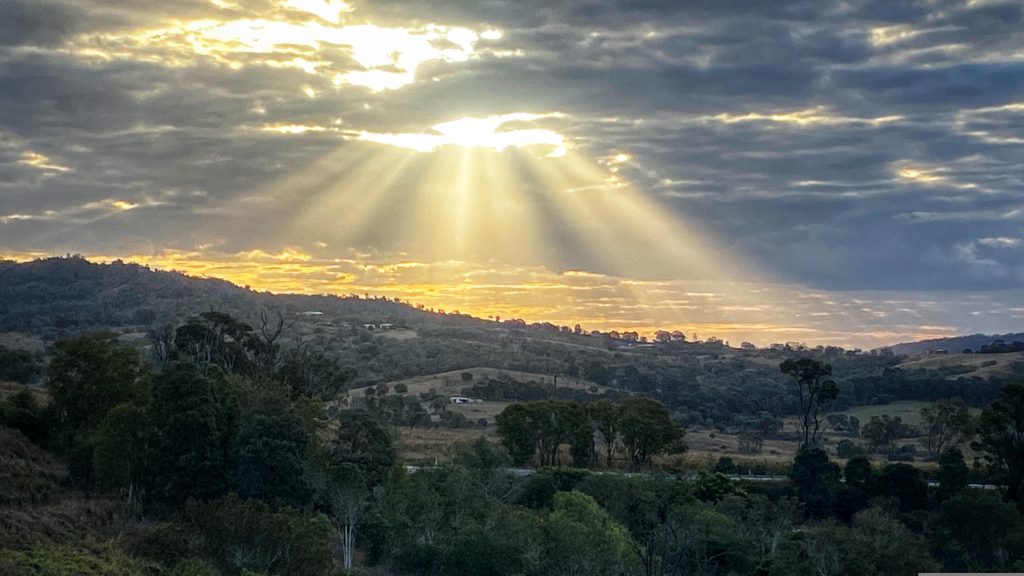 God Rays above a nature valley, before climate change ruins it