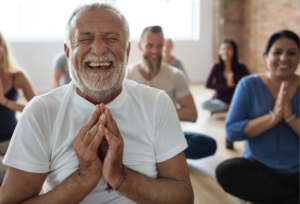 group of people taking part in a laughter yoga class