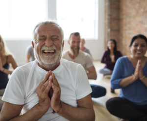A group of people take part in a laughter yoga class