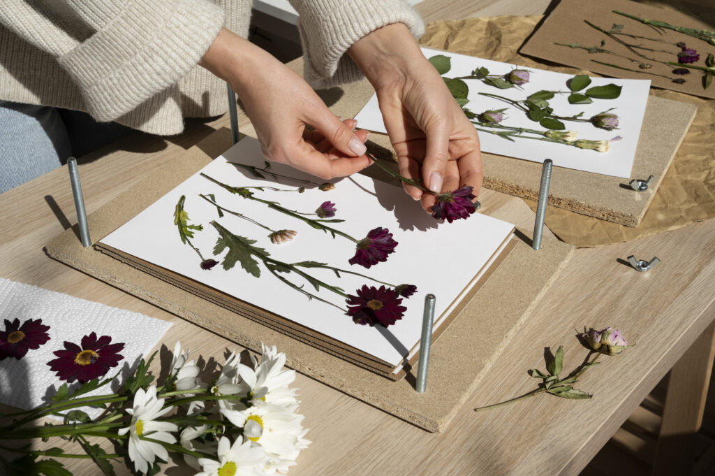 A woman pressing flowers, an example of a sustainable craft