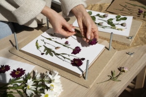 A woman pressing flowers, an example of a sustainable craft